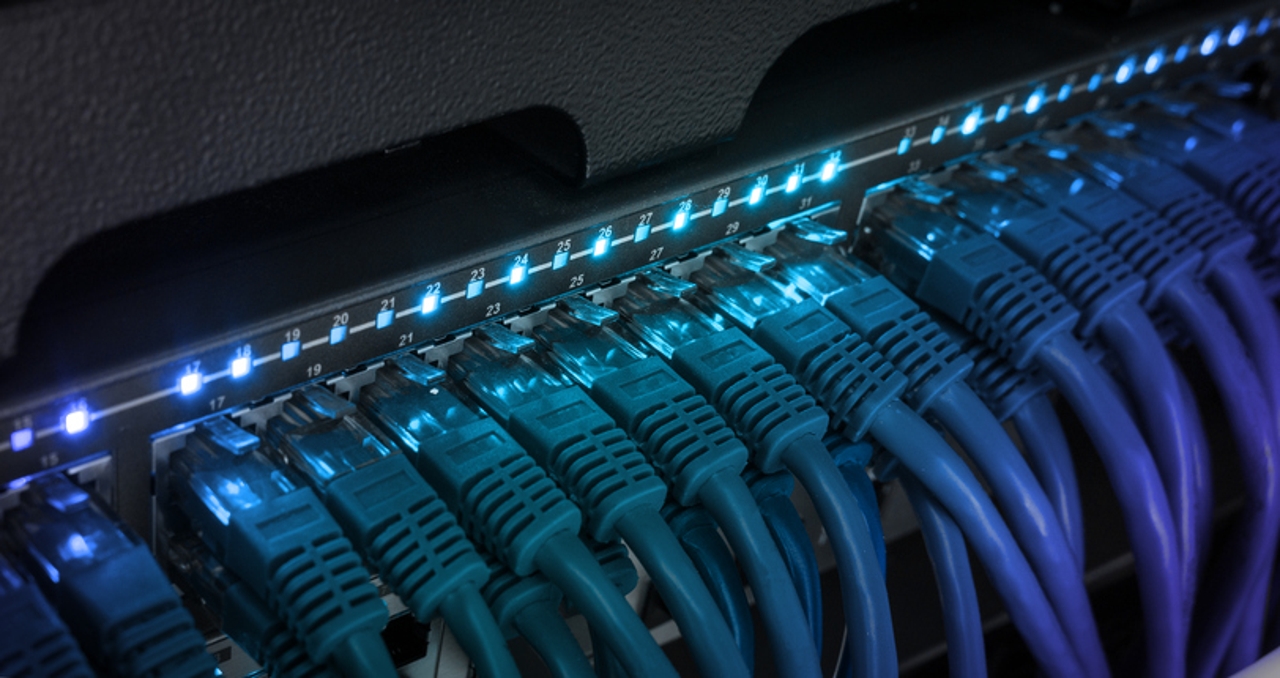 data center network switch with glowing cables - The Year of 100GbE in Data Center Networks